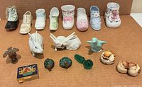 Full group view showing all miniature shoes, animal figurines and pill box