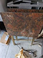 Front view of three faux-marble top folding tables