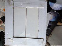 Open box showing white glossy subway tiles