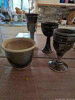 Front view of three goblets and bowl planter on table