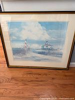 Full view of framed seascape print showing gold frame, mat and artwork