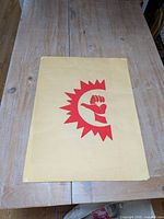 Front of poster showing fist sunburst graphic and edge wear