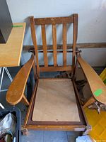 Full view of rocking chair showing arms, seat panel, backrest and wear