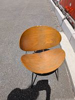 Front view of chair showing curved plywood seat and backrest
