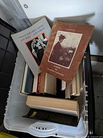 Overview of bin showing assorted photobooks including Women and Other Visions and Atget volume