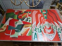 Two large poster compositions laid out on table showing Tabasco pop art and cubist designs