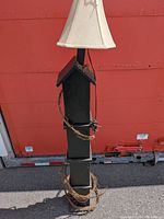 Full view of floor lamp with shade and garland
