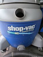 Front view of blue Shop-Vac Contractor canister showing logo and hose port