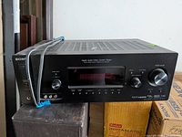 Front and top of Sony AV receiver showing controls, inputs and branding