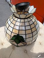 Overall view of stained glass pendant showing color, pattern and canopy