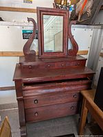 Full view of mahogany dresser with mirror attached