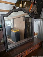Front view of arched dark wood dresser mirror