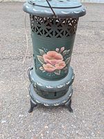 Front view showing floral motif, overall form, feet, cord