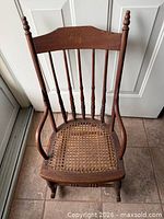 Full view of wooden spindle-back child’s chair