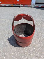 Full view of red wooden bucket with handle