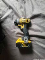 Impact driver with battery attached, left side view