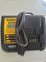 Front view of DeWalt DCB115 charger with power cord wrapped around unit
