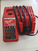 Front view of Milwaukee M12/M18 battery charger showing label and cord