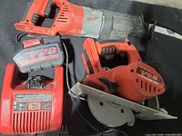 Milwaukee V28 reciprocating saw, circular saw, lithium-ion battery pack, and charger grouped