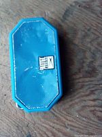 Front view of blue Altec Lansing speaker showing grille and logo