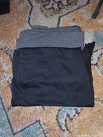 Stacked grey and black Bella tank tops