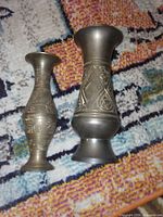 Front view of two etched brass mini vases showing size difference and decorative patterns