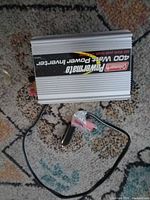 Top view showing Coleman Powermate 400W label and attached cigarette lighter cord