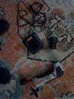 Multi-tool, battery, charger with cord laid out