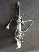 Full view of curling iron and cord on floor