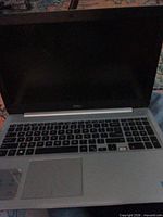 Open Dell laptop showing keyboard, missing one key and Intel sticker