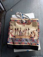 Front view of tapestry tote handbag with Egyptian scene and rope handles