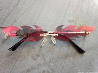 Full view of flame-lensed sunglasses showing lens shape, bridge, and temples