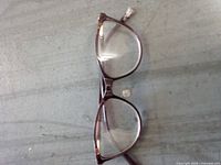 Top view of dark brown plastic frame Foster Grant eyeglasses with clear lenses