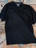 Front view of black Gildan Performance short-sleeve T-shirt laid flat on floor