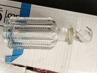 Overall view of clear cut glass bottle with stopper