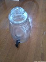 Overall view of glass beverage dispenser with lid and spigot