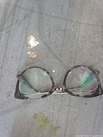 Front view of cat-eye eyeglasses showing frame pattern and clear lenses