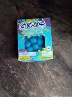 Front of sealed Goblies throwable paintballs box showing blue paintballs through window