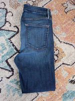 Folded Good American denim jeans showing back pocket and overall fabric condition