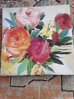 full view of square floral canvas painting on floor
