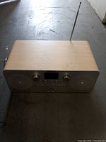 Front/top view of Ion radio CD player showing speakers, controls, display and antenna