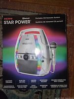 Retail box front showing Ion Star Power portable CD karaoke system with microphone