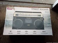 Retail box front of Ion Street Rocker boombox showing product image and feature icons