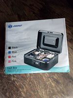 Retail box of JSSMST cash box showing product image and color options