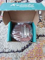 Mini kalimba necklace inside original box