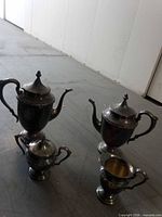Four silver-plated pieces standing upright