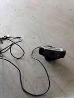 Webcam with attached USB-A cable shown on floor