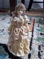 Front view of porcelain figurine showing dress detail and facial features