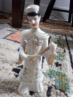 Front view of porcelain figurine in traditional dress