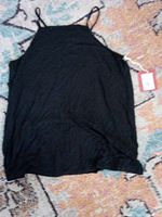 Front view of black Mossimo tank top with tag attached